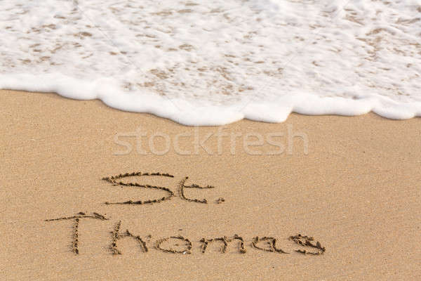 St Thomas written in sand with sea surf Stock photo © backyardproductions