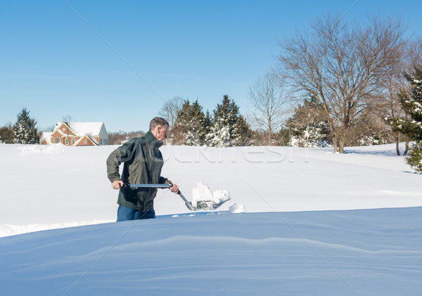 Senior adult man trying to dig out drive in snow Stock photo © backyardproductions