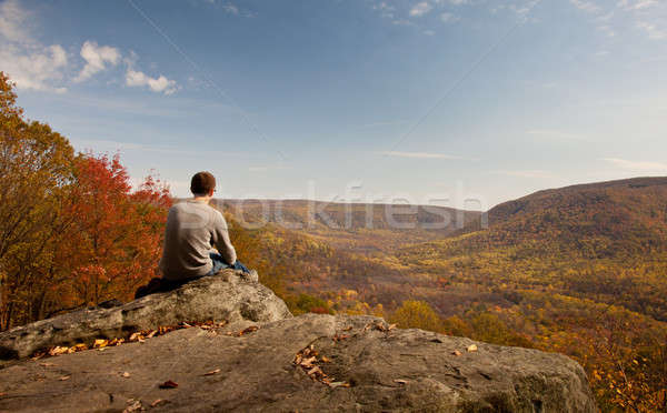 Young hiker relaxing on rock Stock photo © backyardproductions