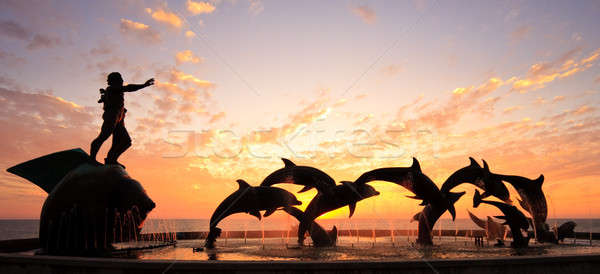 Sunset with statue of Dolphins and Fisherman in Mazatlan  Stock photo © backyardproductions