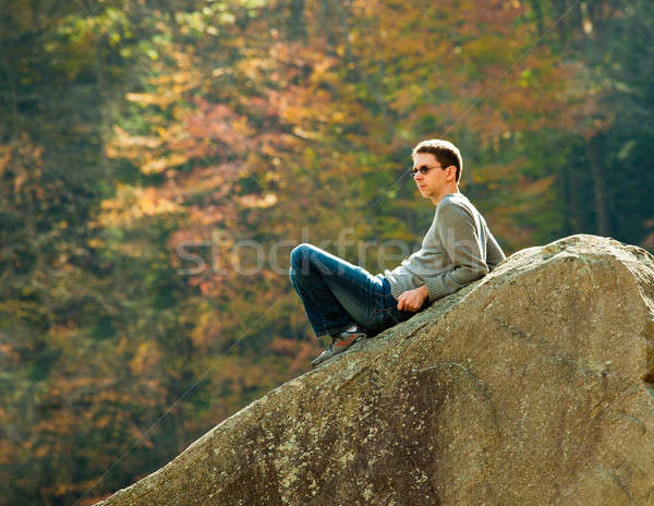 Young hiker relaxing on rock Stock photo © backyardproductions
