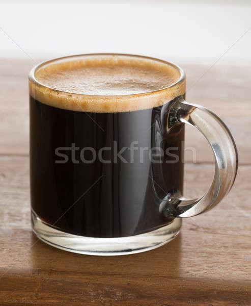 Black coffee and froth in glass mug wood table Stock photo © backyardproductions