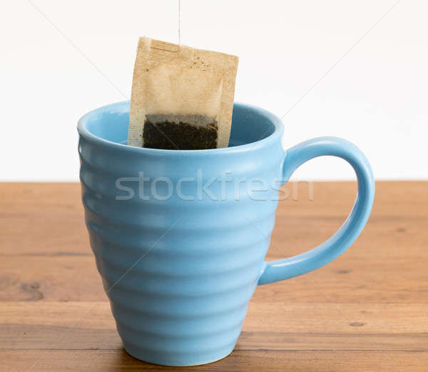 Brown organic green tea bag lowered in mug Stock photo © backyardproductions