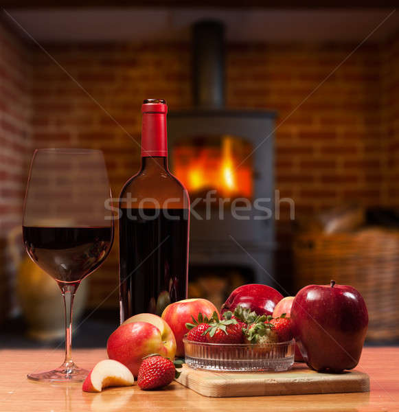 Red wine and fruit in front of burning fire Stock photo © backyardproductions