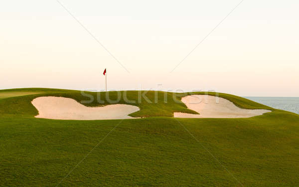 Sand bunker in front of golf green and flag Stock photo © backyardproductions