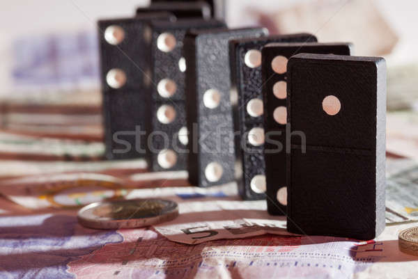 Standing dominoes on bank notes Stock photo © backyardproductions