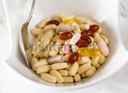 Vitamins in bowl of tablets Stock photo © backyardproductions