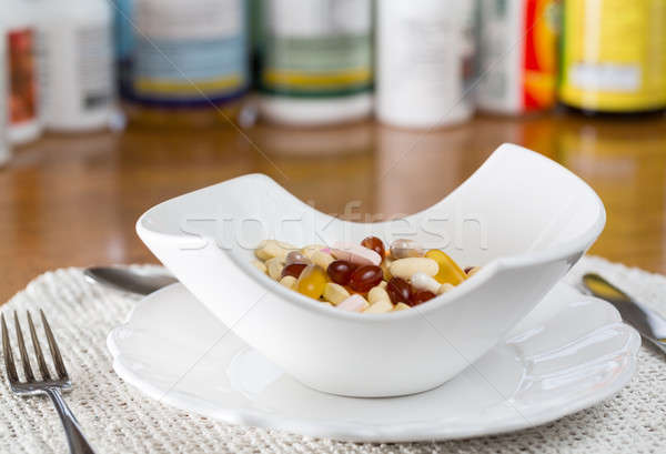 Vitamins in bowl of tablets  Stock photo © backyardproductions