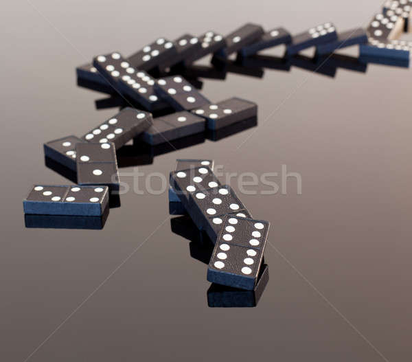 Dominoes collapsed on reflective surface Stock photo © backyardproductions