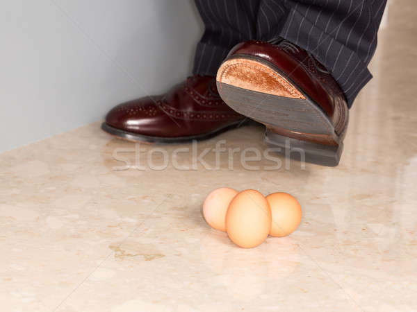 Man's shoe stamping on three eggs Stock photo © backyardproductions