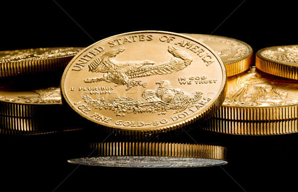 Macro image of gold eagle coin on stack Stock photo © backyardproductions