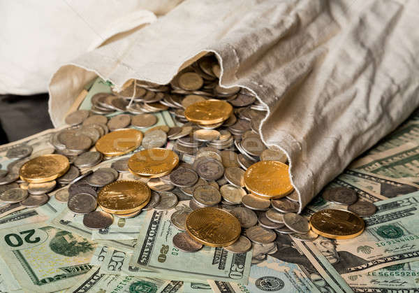 Many US dollar bills or notes with money bag Stock photo © backyardproductions