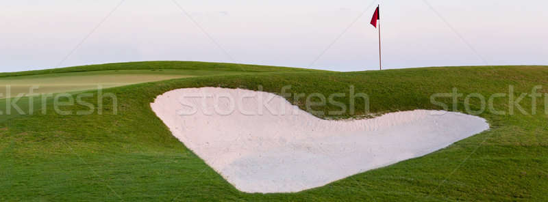 Stock photo: Heart shaped sand bunker in front of golf green