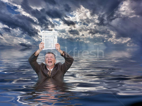 Senior man holding IRS form 1040 in water Stock photo © backyardproductions