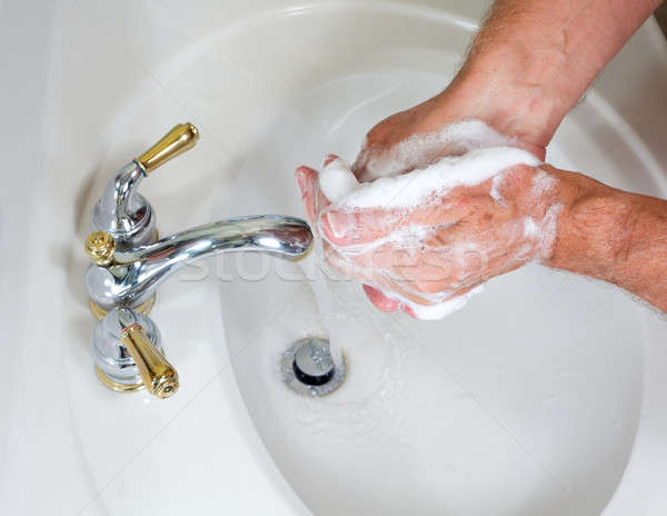 Stock photo: Senior male wash hands with soap