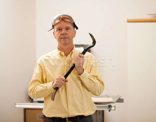 Senior man holding a crowbar Stock photo © backyardproductions