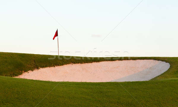 Sand bunker in front of golf green and flag Stock photo © backyardproductions