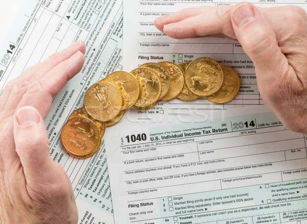 Stock photo: Solid gold coins on 2014 form 1040