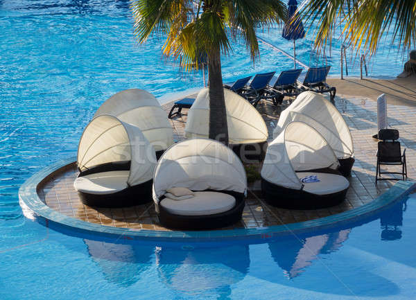 Round relaxing beds by swimming pool Stock photo © backyardproductions