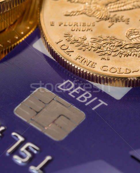 Gold coins on chip and pin debit card Stock photo © backyardproductions