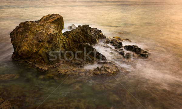 Long exposure sunset on sea rocks Stock photo © backyardproductions