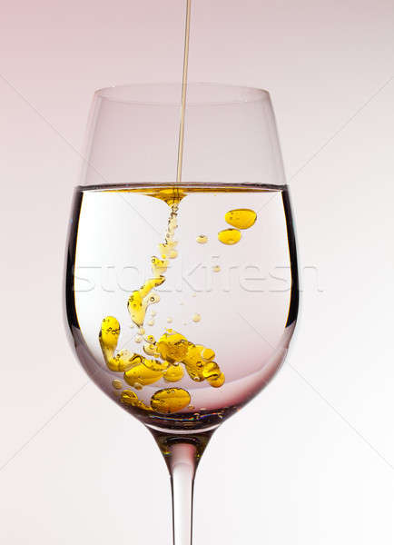Olive oil being poured into wine glass Stock photo © backyardproductions