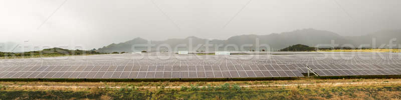 Solar panel power station on cloudy day Stock photo © backyardproductions