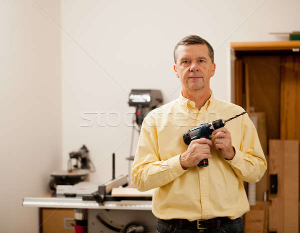 Stock photo: Senior man holding power drill