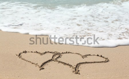 Senior lady draws intertwined hearts Stock photo © backyardproductions