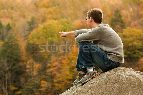 Young hiker relaxing on rock Stock photo © backyardproductions