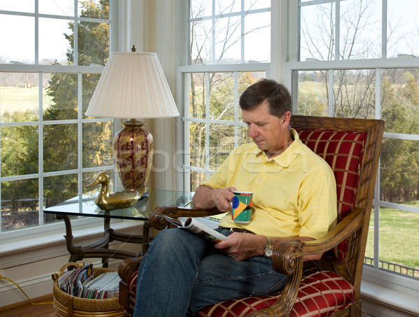 Boomer reading a magazine by garden Stock photo © backyardproductions