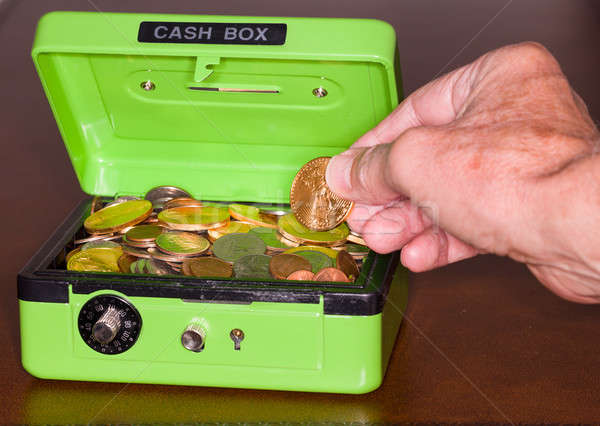 Green cash box with gold and silver coins Stock photo © backyardproductions