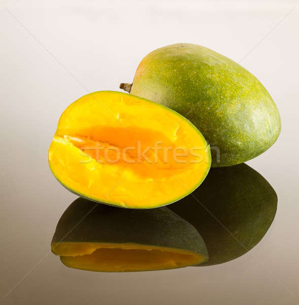 Two mangoes on reflecting surface Stock photo © backyardproductions