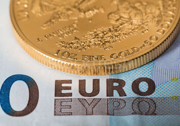 Gold coins on euro note bill with coins Stock photo © backyardproductions