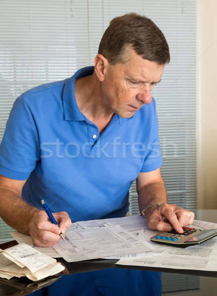 Senior man preparing USA tax form 1040 for 2012 Stock photo © backyardproductions