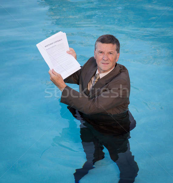 Senior man holding mortgage loan document in water Stock photo © backyardproductions