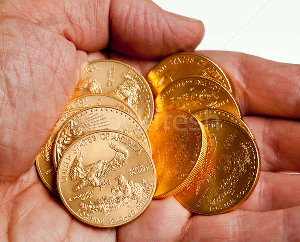 Hand holding stack of gold coins Stock photo © backyardproductions