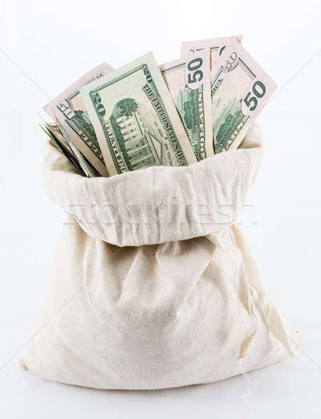 Many US dollar bills or notes with money bags Stock photo © backyardproductions