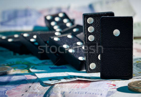Fallen dominoes on bank notes Stock photo © backyardproductions