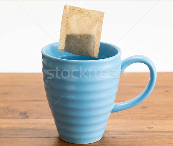 Brown organic green tea bag lowered in mug Stock photo © backyardproductions