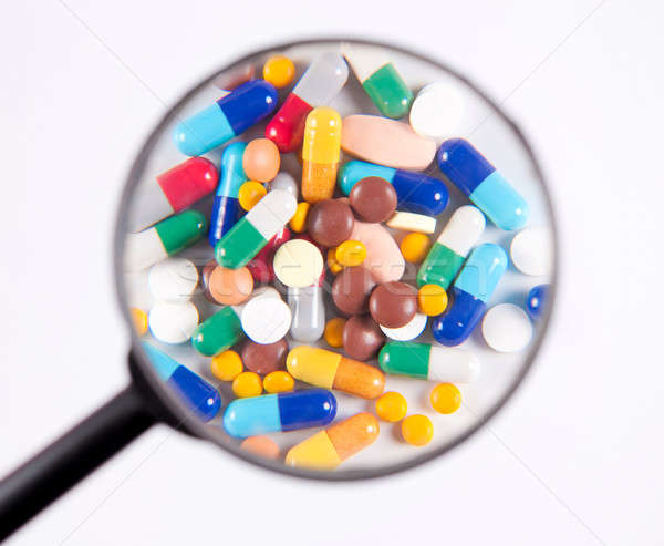 The pills under scrutiny  Stock photo © badmanproduction