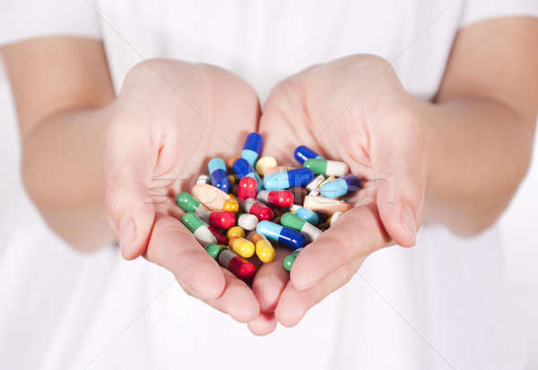 Pills in hands Stock photo © badmanproduction