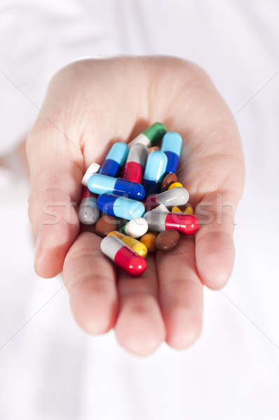 Pills in hands Stock photo © badmanproduction