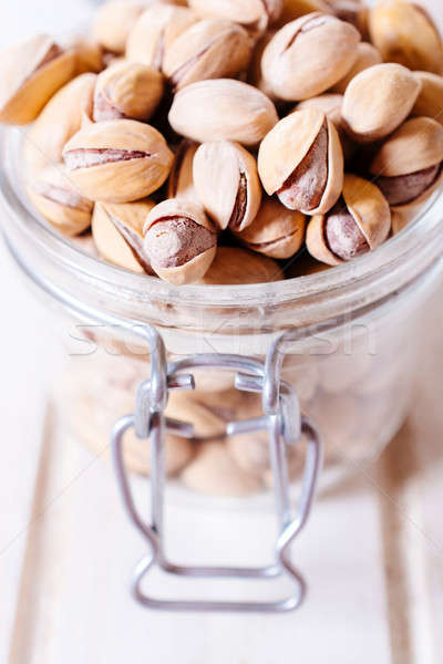 Pistachios in jar Stock photo © badmanproduction