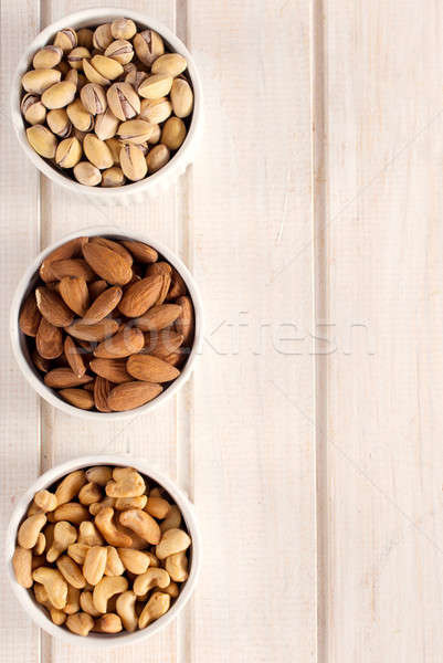 Nuts fruit in bowls Stock photo © badmanproduction