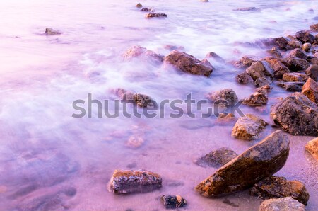 Lila Wasser Steine Meer Langzeitbelichtung Strand Stock foto © badmanproduction