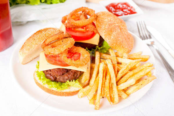 Beef burger and onion rings Stock photo © badmanproduction