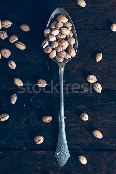 Pistachios in the spoon Stock photo © badmanproduction