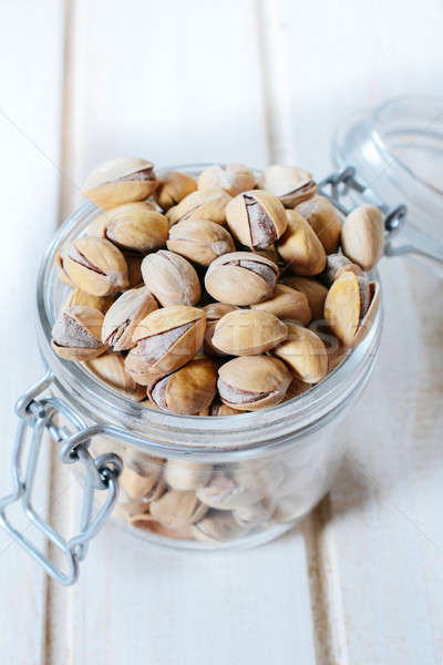 Pistachios in jar Stock photo © badmanproduction