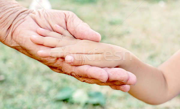 Vieux jeunes mains main enfant aider [[stock_photo]] © badmanproduction